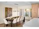 Sunlit dining area features an expansive table set for twelve, modern lighting, and large view windows at 8001 E Voltaire Ave, Scottsdale, AZ 85260