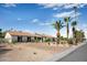 Attractive single-story home featuring a brick driveway, desert plants, and palm trees at 8001 E Voltaire Ave, Scottsdale, AZ 85260