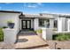 Inviting entryway features a brick path, potted plants, and a double-door entrance, creating curb appeal at 8001 E Voltaire Ave, Scottsdale, AZ 85260