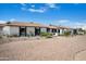 Sprawling one-story home showcases desert landscaping, a brick driveway, and a welcoming facade under a bright blue sky at 8001 E Voltaire Ave, Scottsdale, AZ 85260