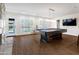 Game room features a pool table, modern lighting, shutters, and an adjacent dining area, perfect for entertainment at 8001 E Voltaire Ave, Scottsdale, AZ 85260