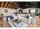 Spacious living room featuring a large sectional sofa, bar area, and a pool table offering a blend of comfort and entertainment at 8001 E Voltaire Ave, Scottsdale, AZ 85260