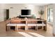 Inviting living room with large leather sofa, wooden table, and a big screen TV for comfortable Gathering time at 8001 E Voltaire Ave, Scottsdale, AZ 85260