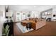 Spacious living room features a comfortable leather sectional sofa, stone fireplace, and large windows for natural light at 8001 E Voltaire Ave, Scottsdale, AZ 85260