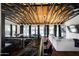 Bright living room showcases an exposed beam ceiling, modern furnishings, and wet bar with marble countertop at 8001 E Voltaire Ave, Scottsdale, AZ 85260