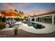 Relaxing pool area featuring lounge chairs, patio umbrellas, and views of the home's expansive backyard at 8001 E Voltaire Ave, Scottsdale, AZ 85260