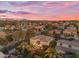 Aerial view of a home with a pool and meticulously landscaped yard set against a vibrant sunset at 824 W Whitten St, Chandler, AZ 85225