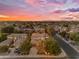 Beautiful sunset aerial of a neighborhood with manicured lawns and luxurious single-Gathering houses at 824 W Whitten St, Chandler, AZ 85225