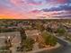 Gorgeous aerial view of a luxury home and landscaped front yard at dusk with colorful sky at 824 W Whitten St, Chandler, AZ 85225