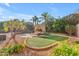 Lush backyard with a swimming pool, artificial grass, lounge chairs, and mature landscaping at 824 W Whitten St, Chandler, AZ 85225