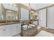 Luxurious bathroom with a corner tub, granite counters, dual sinks, and decorative chandelier at 824 W Whitten St, Chandler, AZ 85225