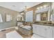 Luxurious bathroom with a corner tub, granite counters, dual sinks, and decorative chandelier at 824 W Whitten St, Chandler, AZ 85225
