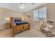 A well-lit bedroom with hardwood floors, a fan, and a beautifully decorated bed at 824 W Whitten St, Chandler, AZ 85225