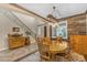Formal dining room showcasing a wooden table, stylish light fixture, and wood-paneled accent wall at 824 W Whitten St, Chandler, AZ 85225