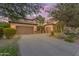 Spacious home featuring a three-car garage, desert landscaping, and a large driveway at 824 W Whitten St, Chandler, AZ 85225