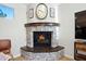 Inviting stone fireplace with custom mantle, clock above, creating a cozy focal point in the living space at 824 W Whitten St, Chandler, AZ 85225