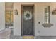Inviting front entry with decorative iron security door, wreath, and charming details at 824 W Whitten St, Chandler, AZ 85225