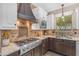 Kitchen with stone backsplash, stainless steel range hood and gas cooktop at 824 W Whitten St, Chandler, AZ 85225