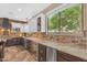 Gourmet kitchen with stone backsplash, stainless steel appliances, and a beverage cooler at 824 W Whitten St, Chandler, AZ 85225