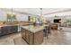 Open-concept kitchen with an island, stainless steel appliances, and custom cabinetry at 824 W Whitten St, Chandler, AZ 85225