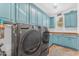 Well-lit laundry room with a large washer and dryer set and plenty of cabinet space at 824 W Whitten St, Chandler, AZ 85225