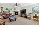 Bright living room with a stone fireplace, plush seating, and ample natural light from numerous windows at 824 W Whitten St, Chandler, AZ 85225