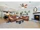 Spacious living room with sofas, stone fireplace, and adjacent kitchen, perfect for entertaining guests at 824 W Whitten St, Chandler, AZ 85225