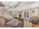 Spacious living room featuring a cozy bed, staircase, and view to the exterior of the house at 824 W Whitten St, Chandler, AZ 85225