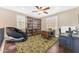 Well-lit living space with hard wood floors, a ceiling fan, and large bookshelves at 824 W Whitten St, Chandler, AZ 85225