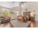 Primary bedroom with tall ceiling, hardwood floors, stylish furniture, two end tables, and an arm chair at 824 W Whitten St, Chandler, AZ 85225