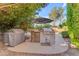 An outdoor kitchen area featuring a grill, beverage cooler, and stone accents at 824 W Whitten St, Chandler, AZ 85225