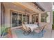 Undercover patio with dining table next to a sliding glass door at 824 W Whitten St, Chandler, AZ 85225