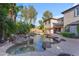 A backyard oasis with a freeform pool, rock features, and mature landscaping at 824 W Whitten St, Chandler, AZ 85225
