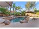Beautiful backyard pool with a rock waterfall, lounge area, and mature landscaping at 824 W Whitten St, Chandler, AZ 85225