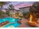 Inviting backyard pool featuring a fire pit, rock features, and outdoor seating area at dusk at 824 W Whitten St, Chandler, AZ 85225