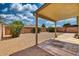 A covered patio overlooks a spacious backyard with a privacy wall at 8501 W Highland Ave, Phoenix, AZ 85037