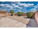 A large backyard features a block wall for privacy and minimal foliage at 8501 W Highland Ave, Phoenix, AZ 85037