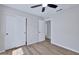 This bedroom features wood floors, a closet, a ceiling fan and neutral paint at 8501 W Highland Ave, Phoenix, AZ 85037