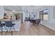 Open-concept living space features an elegant dining area connecting the kitchen and living room, with hardwood floors at 8501 W Highland Ave, Phoenix, AZ 85037