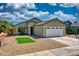 Inviting single-story home with a well-manicured desert landscape, lush green turf and a two-car garage at 8501 W Highland Ave, Phoenix, AZ 85037