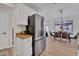 A bright kitchen with stainless steel refrigerator and dining room in background at 8501 W Highland Ave, Phoenix, AZ 85037