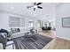 Bright living room with modern decor, light wood floors, stylish rug, and comfortable seating area at 8501 W Highland Ave, Phoenix, AZ 85037