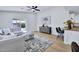 Bright living room with neutral color scheme, stylish seating, and sliding glass doors to backyard at 8501 W Highland Ave, Phoenix, AZ 85037