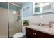 A clean bathroom features a shower, a sink with granite countertops, and a tiled backsplash at 8818 W Pinchot Ave, Phoenix, AZ 85037