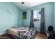Bedroom with blue painted walls and window with curtains at 8818 W Pinchot Ave, Phoenix, AZ 85037