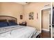 Bedroom showcasing natural light, decorated walls, and wood floors at 8818 W Pinchot Ave, Phoenix, AZ 85037