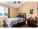 Bedroom with a neutral color scheme, window views, and ceiling fan at 8818 W Pinchot Ave, Phoenix, AZ 85037