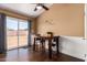 Bright dining room featuring a wood table, a ceiling fan, and sliding glass doors to the backyard at 8818 W Pinchot Ave, Phoenix, AZ 85037