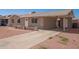 Quaint home showcasing a functional carport and straightforward desert landscape design at 8818 W Pinchot Ave, Phoenix, AZ 85037