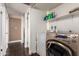 Laundry room featuring a washer and dryer, with hallway in the background at 8818 W Pinchot Ave, Phoenix, AZ 85037